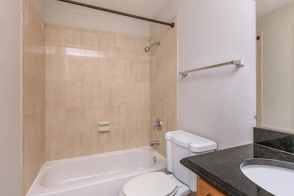 a bathroom with a sink toilet and bath tub and a shower curtain