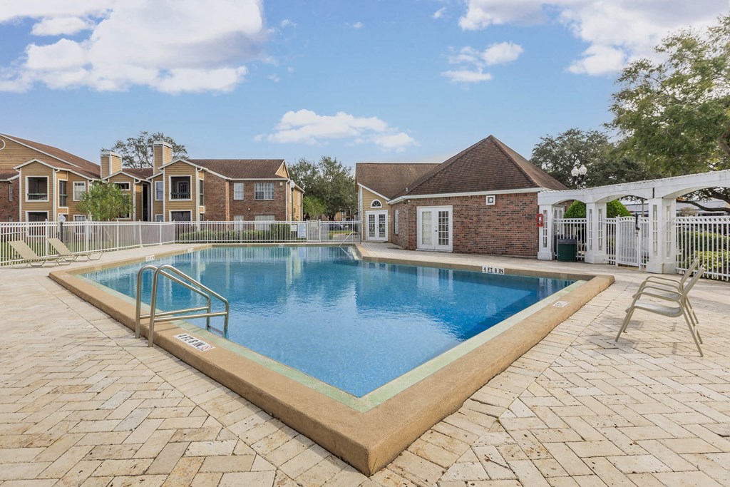 a swimming pool with a house in the background