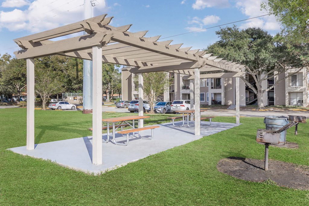 a picnic area with a grill in a park