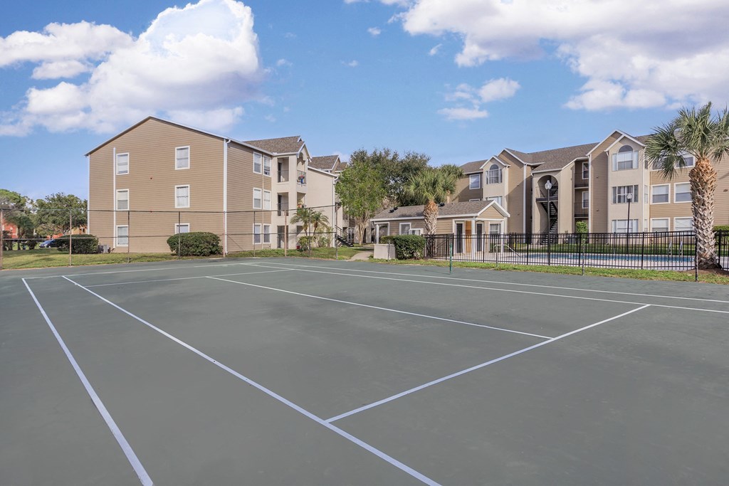 the tennis courts at the whispering winds apartments in pearland tx