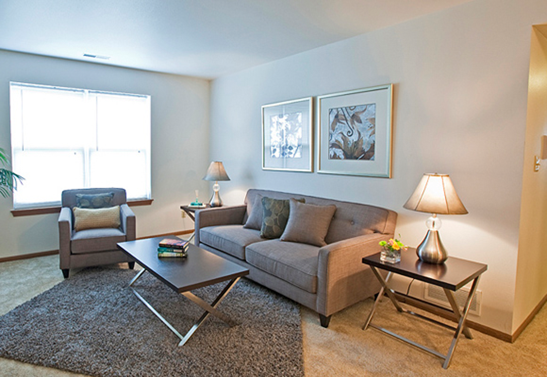 a living room with a couch and two tables