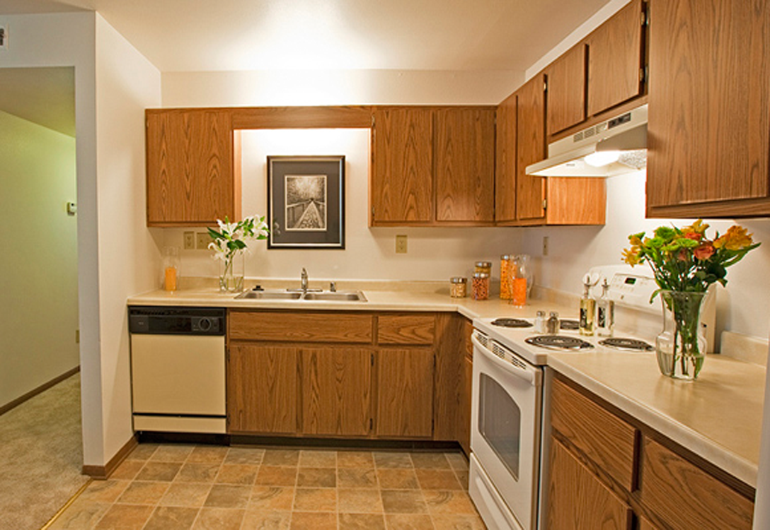 a kitchen with wooden cabinets and white appliances
