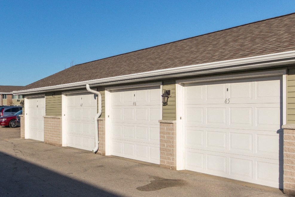 a row of garages with white garage doors