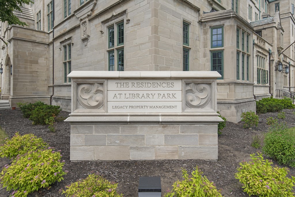 a stone sign in front of a building with the sciences at university park