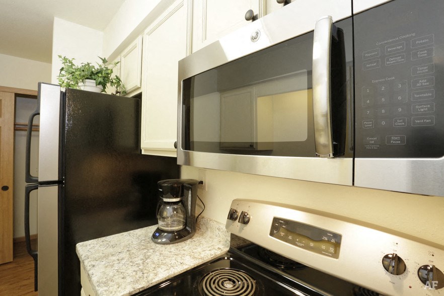 a kitchen with a stove and a microwave