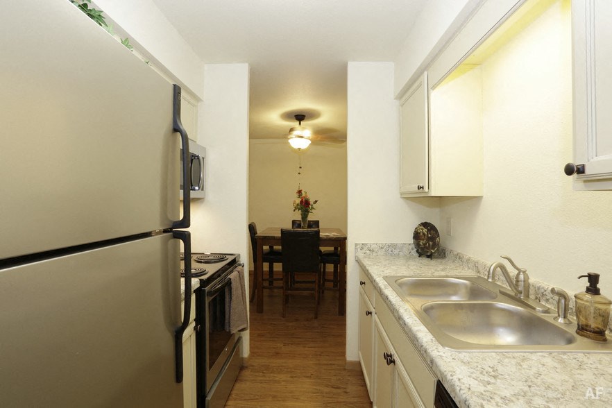 a kitchen with stainless steel appliances and granite counter tops
