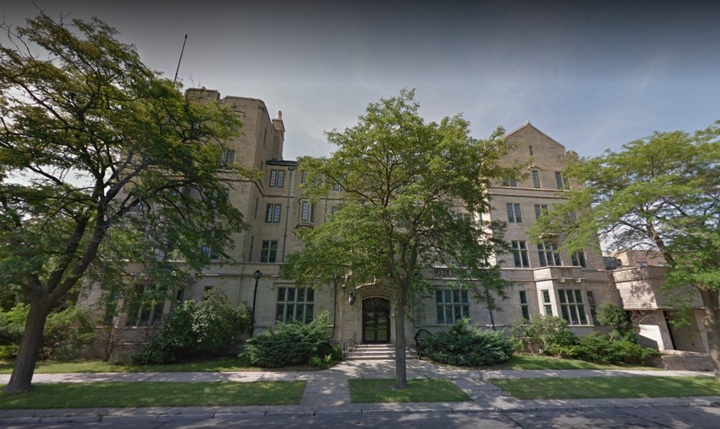 an old building with trees in front of it