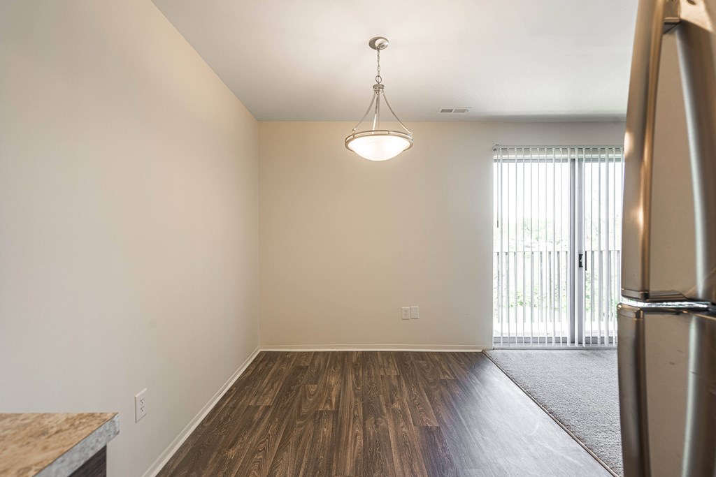 Spacious dining room with natural light at Knottingham Apartments in Clinton Township, MI