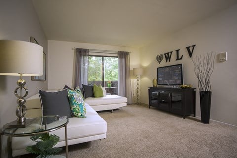 Spacious living room at Woodland Villa Apartments in Michigan