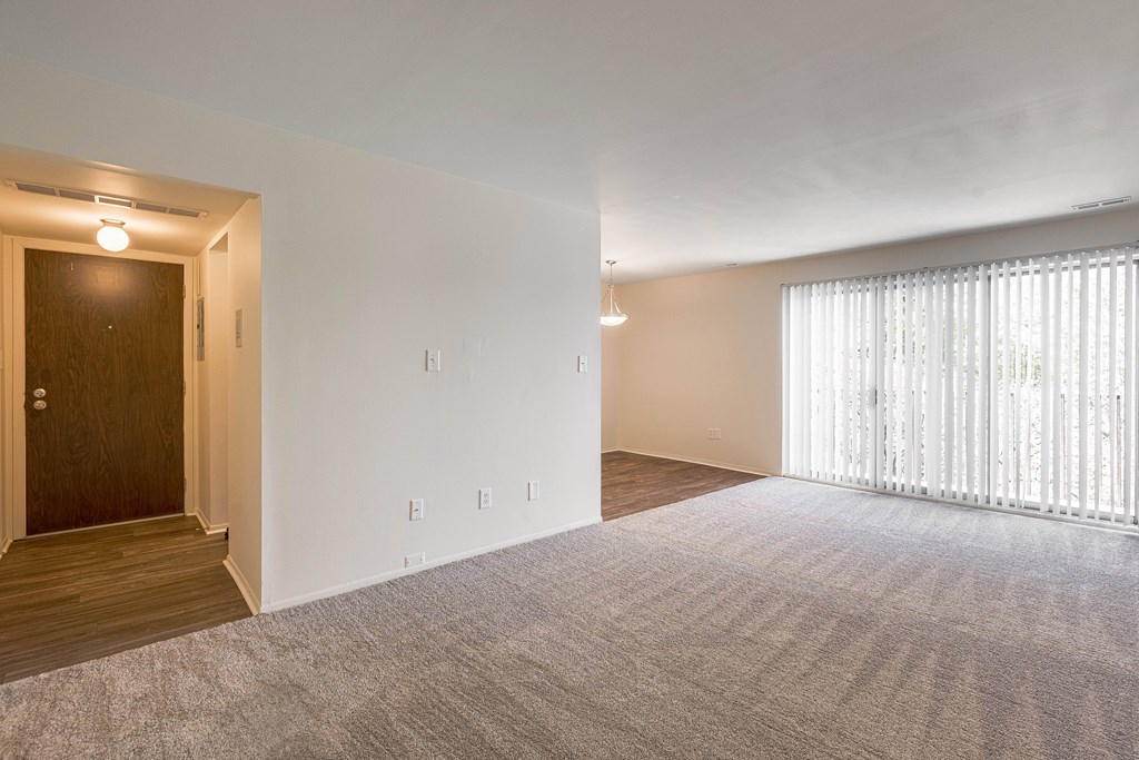 Open and airy entry way and living room at Knottingham Apartments in Clinton Township, MI