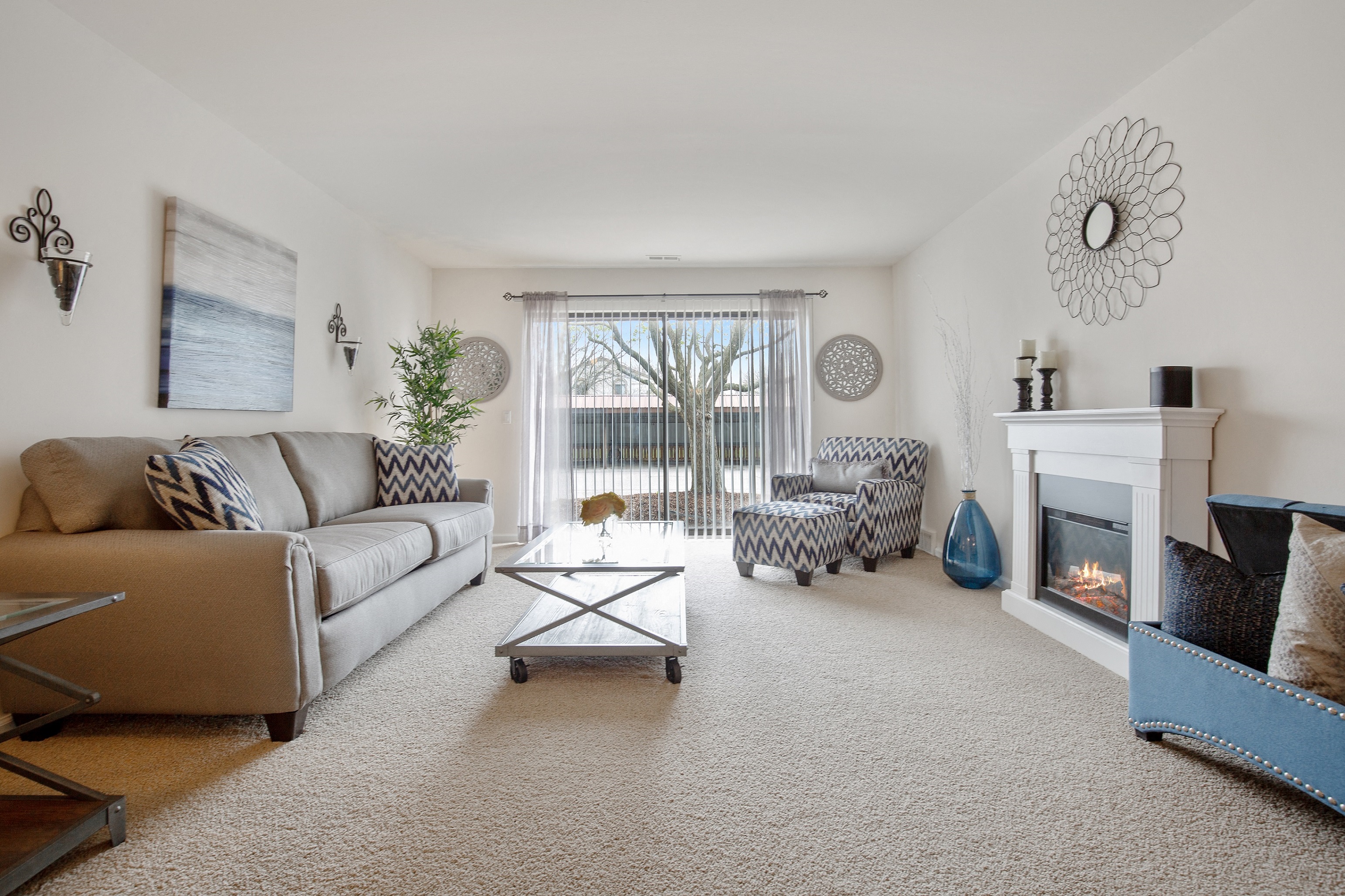 Living Room with Sliding Glass Door at Lakeside Village Apartments Clinton Township MI