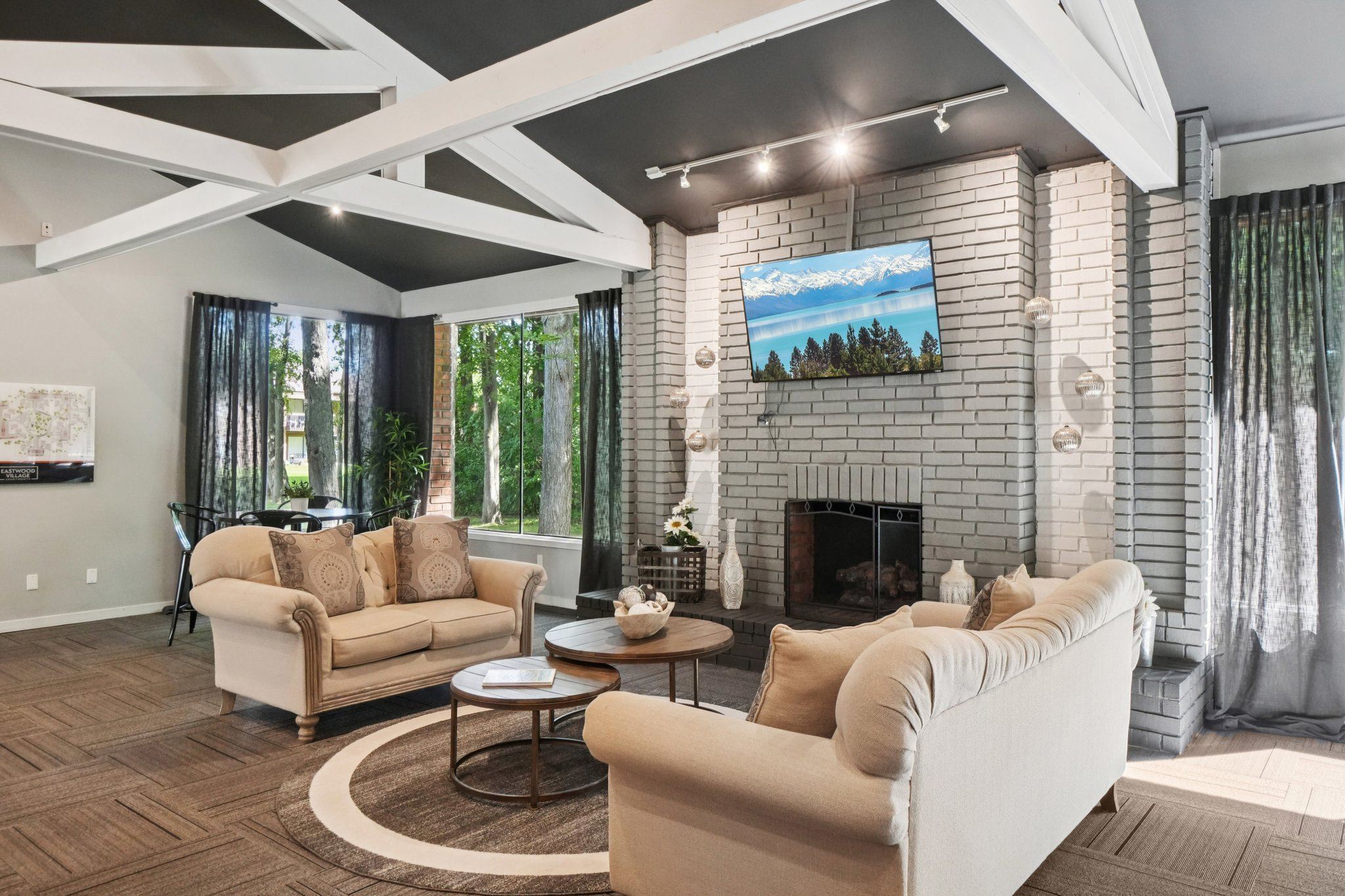A living room with a fireplace and a painting on the wall.
