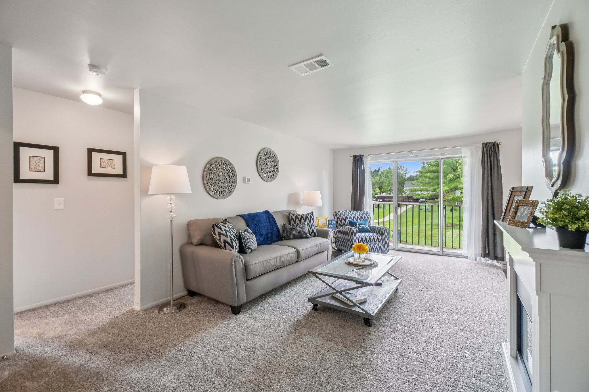 A living room with a grey couch and a white coffee table.