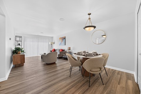 Open concept Living-Dining Area with natural lighting at Lakeside Village Apartments Clinton Township, MI