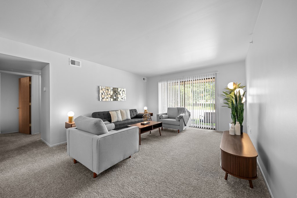 Living room with patio at Dover Hills Apartments in Kalamazoo