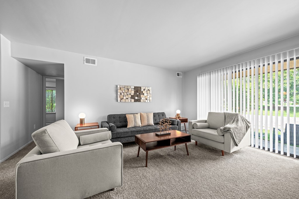 Living room with patio at Dover Hills Apartments in Kalamazoo