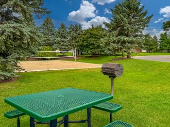 Expansive green space with picnic area at Dover Hills Apartments in Kalamazoo, MI.