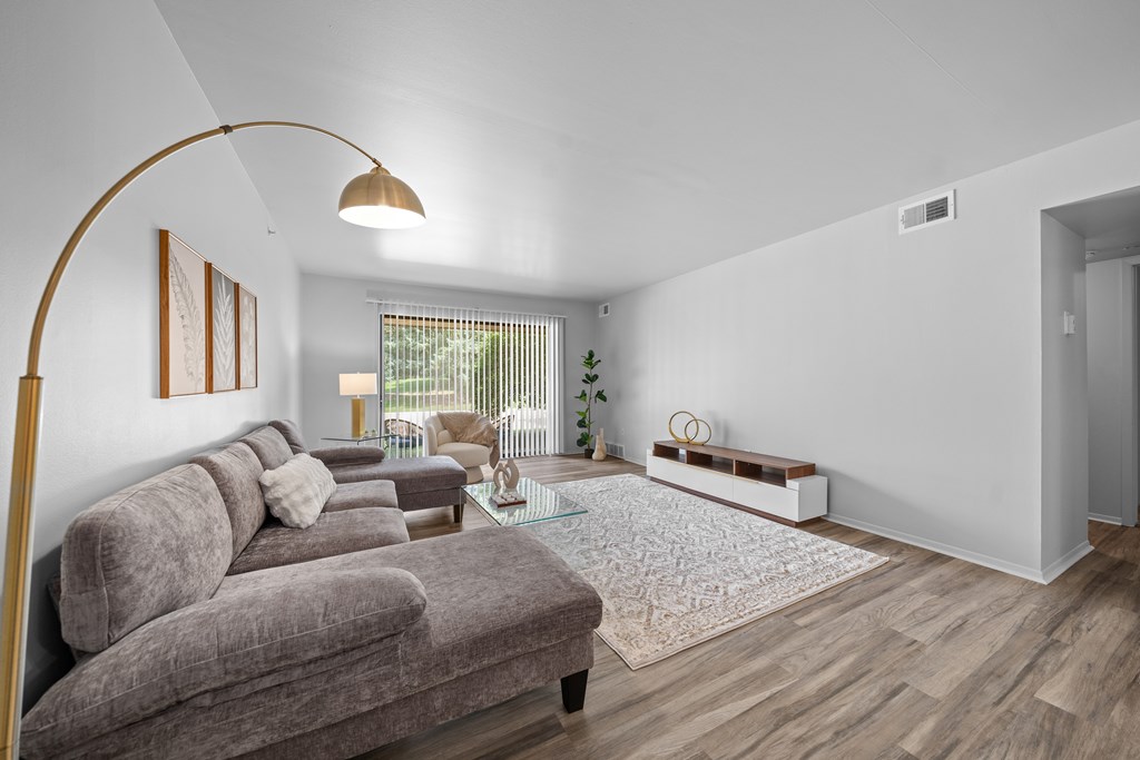 Living room with patio at Dover Hills Apartments in Kalamazoo