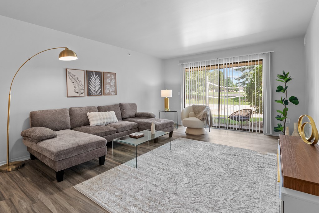 Living room with patio at Dover Hills Apartments in Kalamazoo