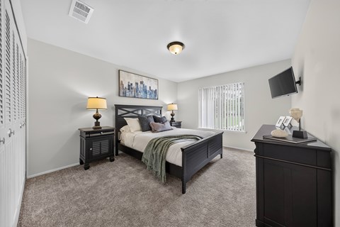 Cozy bedroom with ample storage space at Drawbridge Apartments in Harrison Township, MI.