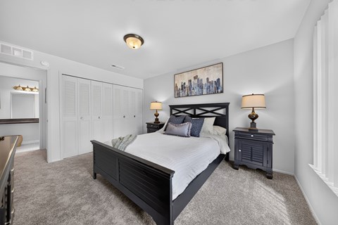 Cozy bedroom with ample storage space at Drawbridge Apartments in Harrison Township, MI.