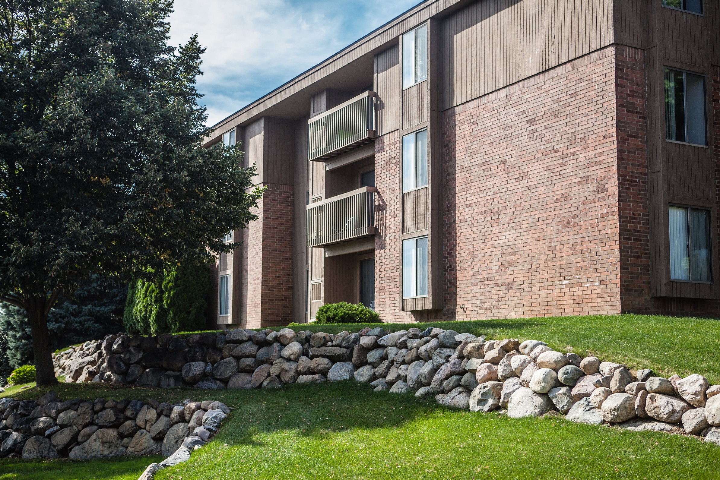 Exterior building with trees in courtyard at Dover Hills Apartments in Kalamazoo, MI