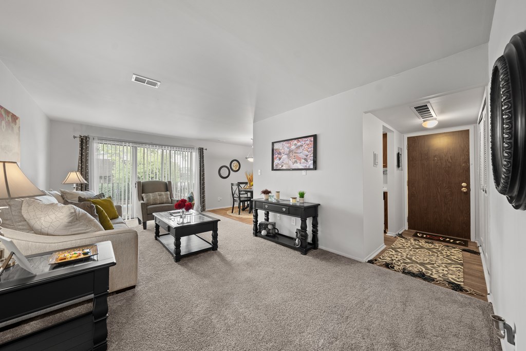 Open and airy living room with natural lighting at Knottingham Apartments in Clinton Township, MI.