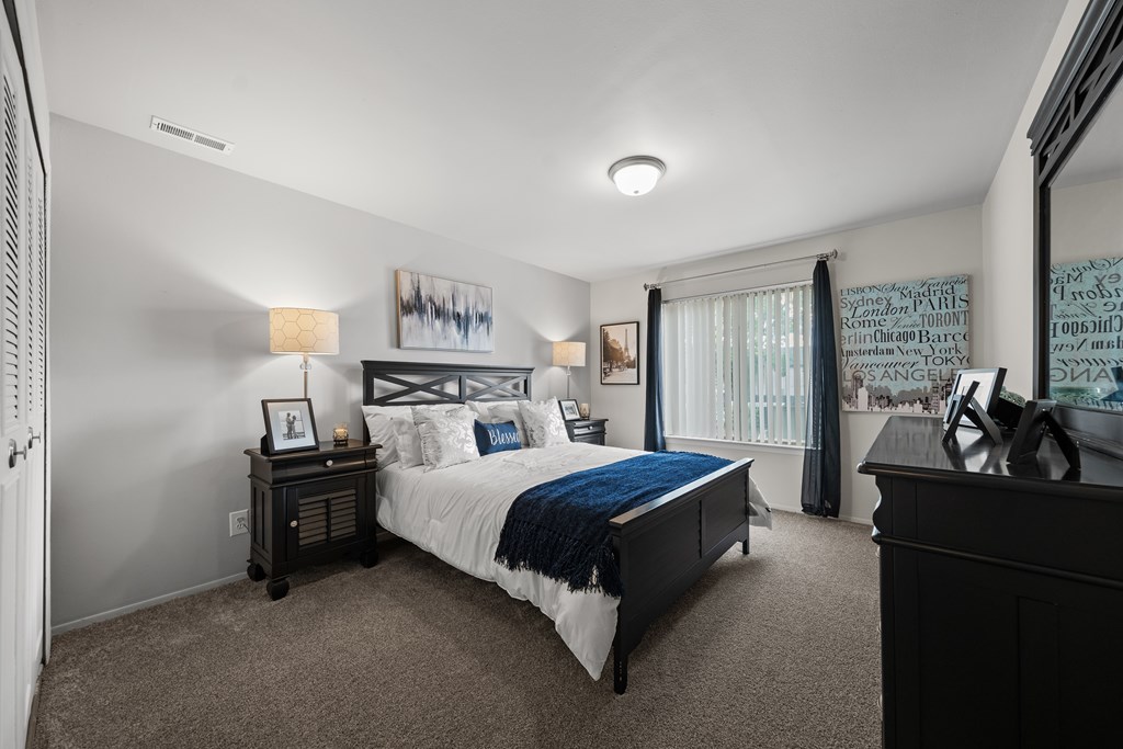 Spacious bedroom with ample storage space at Knottingham Apartments in Clinton Township, MI.