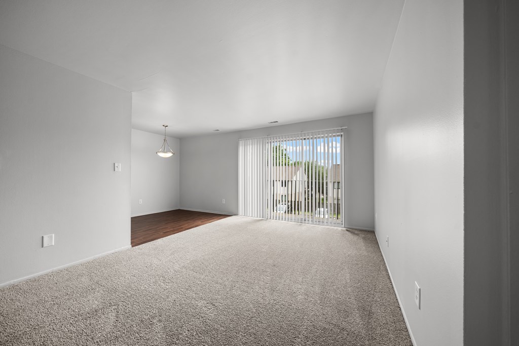 Open and airy living room with natural lighting at Knottingham Apartments in Clinton Township, MI.
