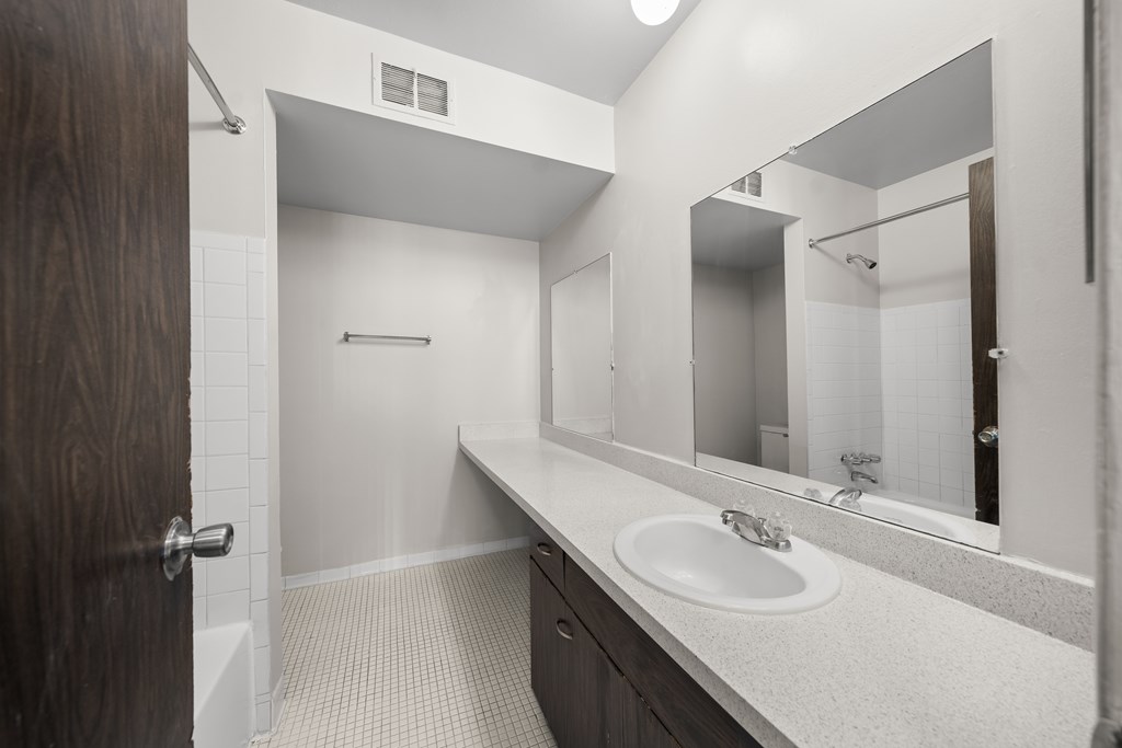 Elevated bathroom with ample storage space at Knottingham Apartments in Clinton Township, MI.