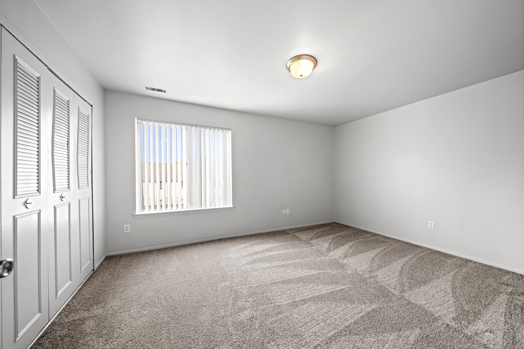Spacious bedroom with ample storage space at Knottingham Apartments in Clinton Township, MI.