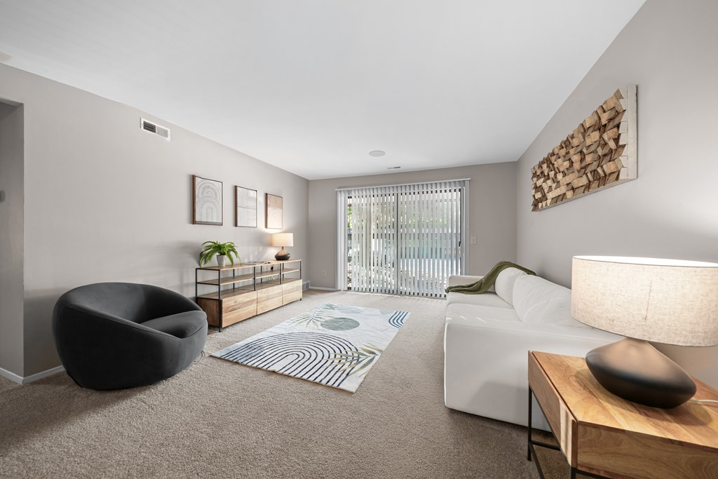 Spacious Living Room with Sliding Glass Door at Lakeside Village Apartments Clinton Township MI