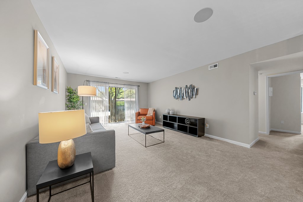 Spacious Living Room with Sliding Glass Door at Lakeside Village Apartments Clinton Township MI