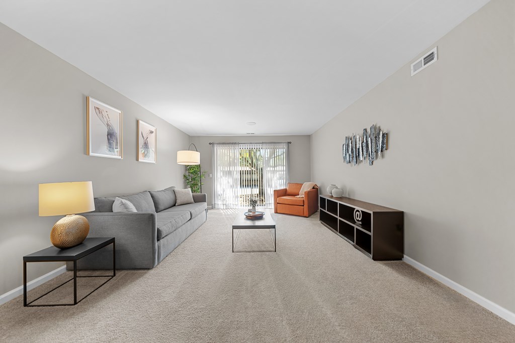 Spacious Living Room with Sliding Glass Door at Lakeside Village Apartments Clinton Township MI