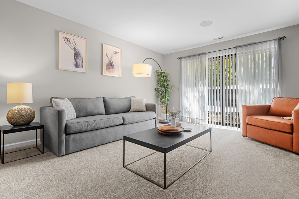 Spacious Living Room with Sliding Glass Door at Lakeside Village Apartments Clinton Township MI