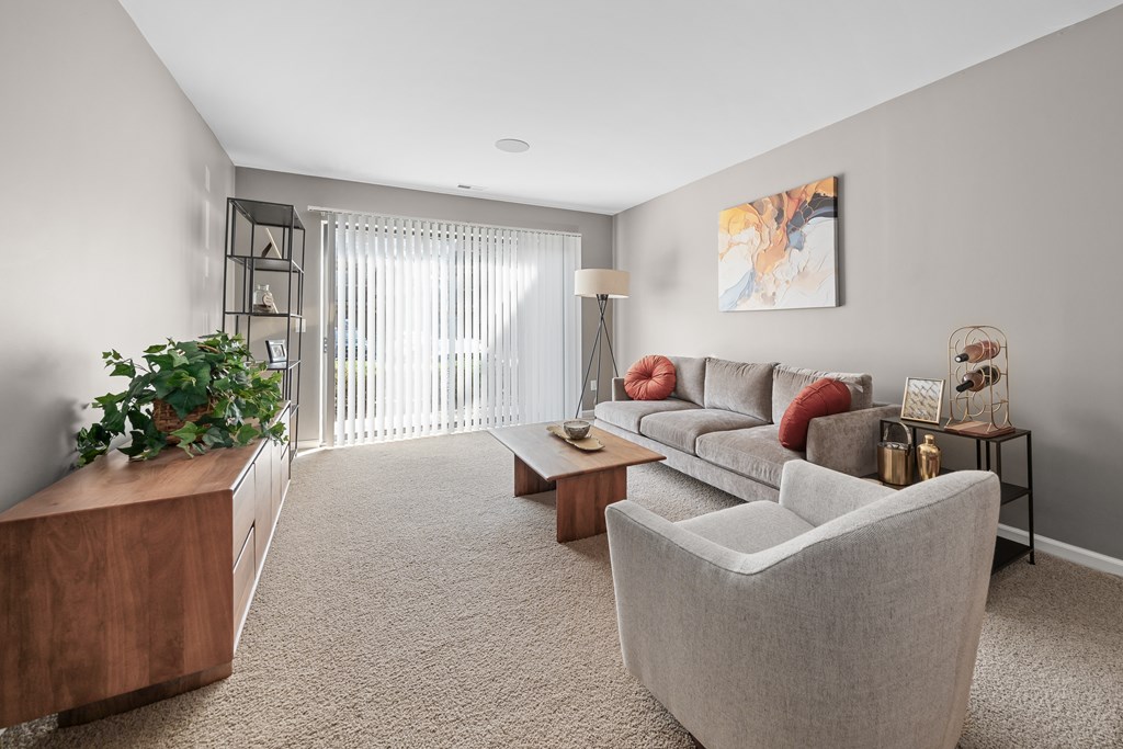 Spacious Living Room with Sliding Glass Door at Lakeside Village Apartments Clinton Township MI