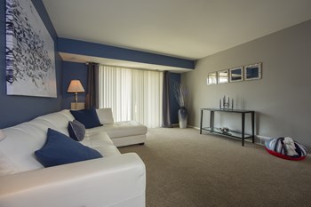 Floorplans that allow for unlimited furniture arrangements Large spacious living room with sliding glass door at Westwood Village Aparments in Westland, Michigan - Photo Gallery 3