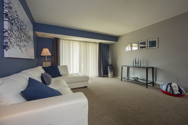 Large spacious living room with sliding glass door at Westwood Village Aparments in Westland, Michigan - Photo Gallery 3
