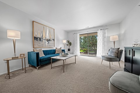 Spacious Living room with patio at Prentiss Pointe Apartments in Harrison Township