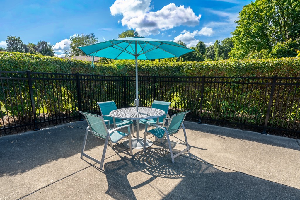 Umbrella and Chairs on Sundeck at Westwood Village Apartments in Westland