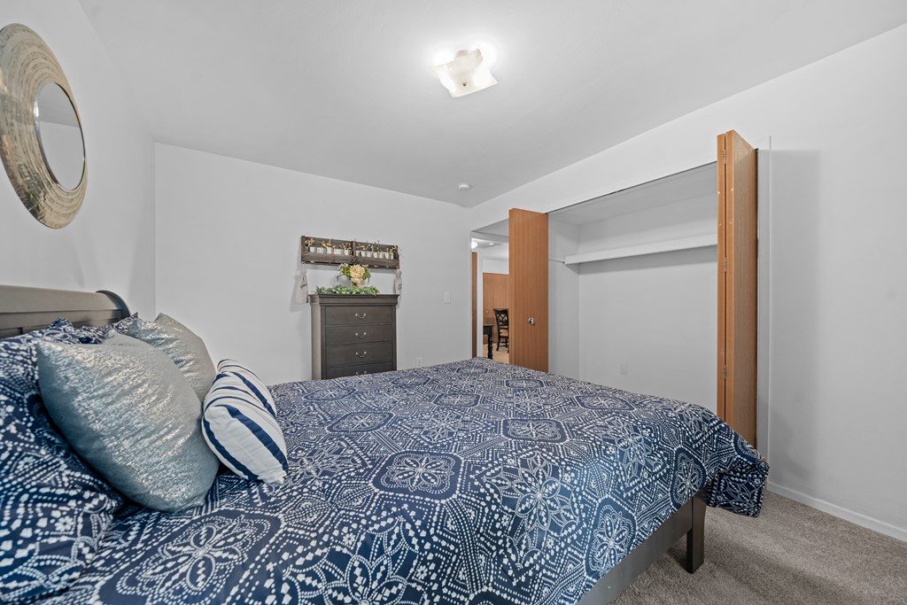 Comfortable bedroom with natural lighting at Westwood Village Apartments in Westland, MI