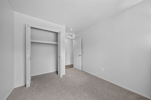 Cozy bedroom with ample storage at Woodland Villa Apartments in Westland, MI.