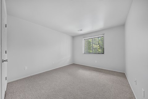 Spacious bedroom at Woodland Villa Apartments in Westland, MI.
