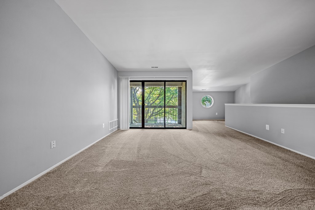 Gorgeous living room with balcony at Park Lane Apartments in Southfield, MI