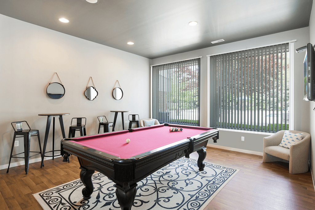 a game room with a pink pool table and bar stoolsat Prentiss Pointe Apartments, Harrison Township, 48045