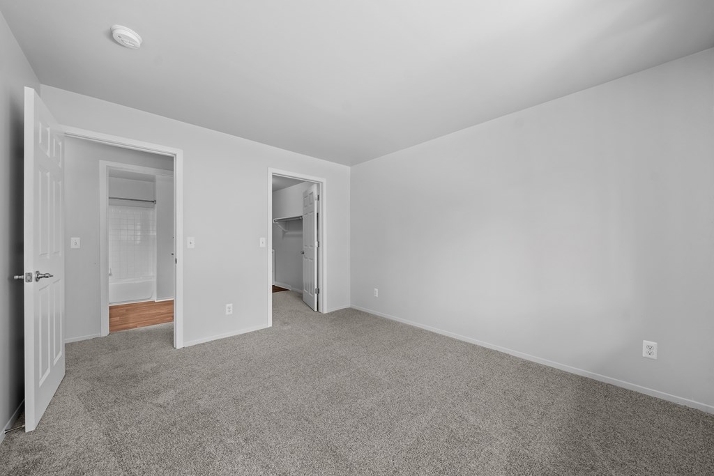 Spacious bedroom with ample storage space at Woodland Villa Apartments in Westland, MI.