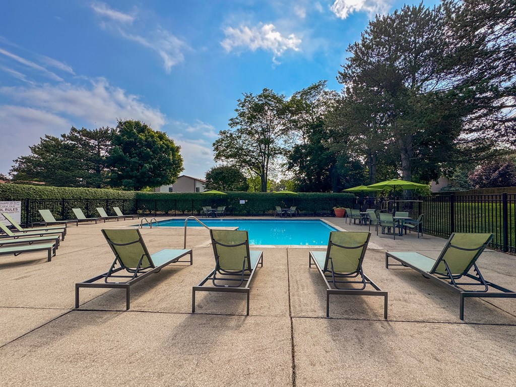 Swimming pool with sundeck at Woodland Villa Apartments in Westland, MI.