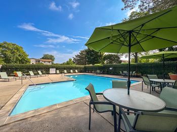 Swimming pool with sundeck at Woodland Villa Apartments in Westland, MI.