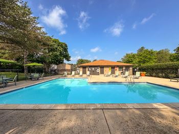 Swimming pool with sundeck at Woodland Villa Apartments in Westland, MI.
