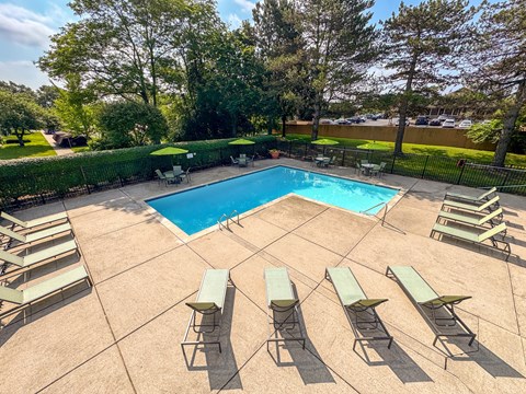 Swimming pool with sundeck at Woodland Villa Apartments in Westland, MI.